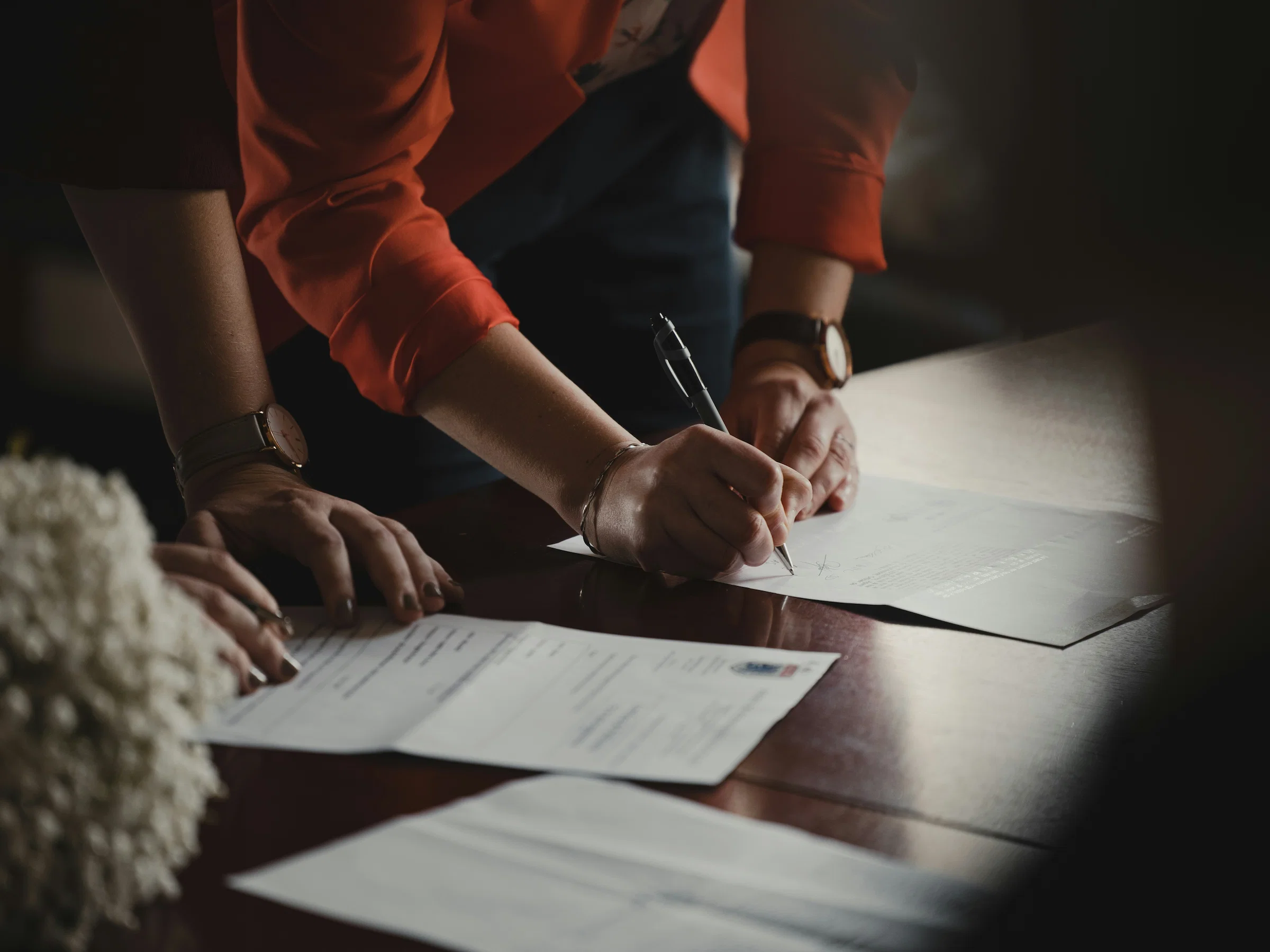 Homeowner and builder reviewing a written agreement before work starts